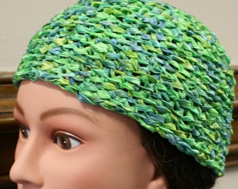 A beautiful green ribbon cloche hat.  Light, airy and green. Hand crocheted textured ribbon in shades of green is perfect