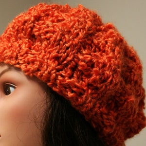 Hand knitted slouchy hat that is a mouth watering tangerine orange. Made with Silky Soft Bulky Yarn