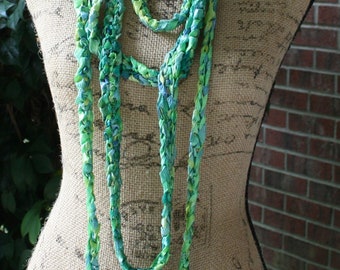 Wrap it, tangle it, slip it on and go tropical with these hand crocheted ribbon ropes In shades of green.  Comes as a set of two