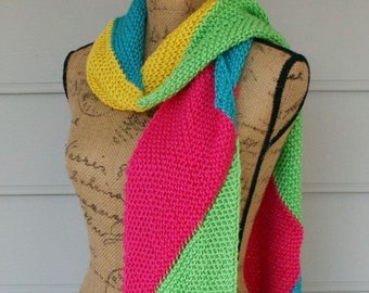 A  scarf of many colors.   Hand Knitted in Yummy colors of Hot Pink, Lime Green, Turquoise and Lemon Yellow.