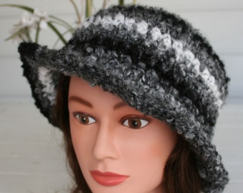 A Winter Hat that is thick soft and cozy.  Black Gray and White Hand Crocheted bucket hat