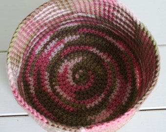 This adorable hand chrocheted basket is made with pink camo yarn.