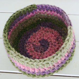 Pinks Purples and Greens make this basket a garden delight.  Hand Crocheted with a thick soft yarn