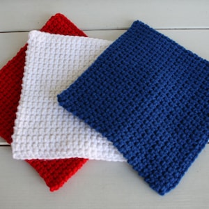 May include: Three crocheted squares in red, white, and blue. The squares are made with a simple stitch and are a great way to add a touch of color to any room.