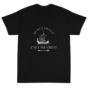 May include: Black t-shirt with a white graphic design. The design features a Viking ship with the text "Descendant of Cnut the Great" and an arrow.