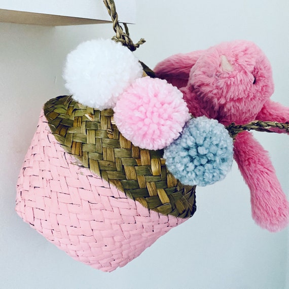 Pink Mini Seagrass Basket with pink, grey and white pom poms.
