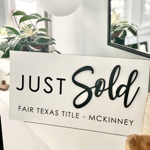 May include: White sign with black text that reads "JUST Sold FAIR TEXAS TITLE - MCKINNEY".