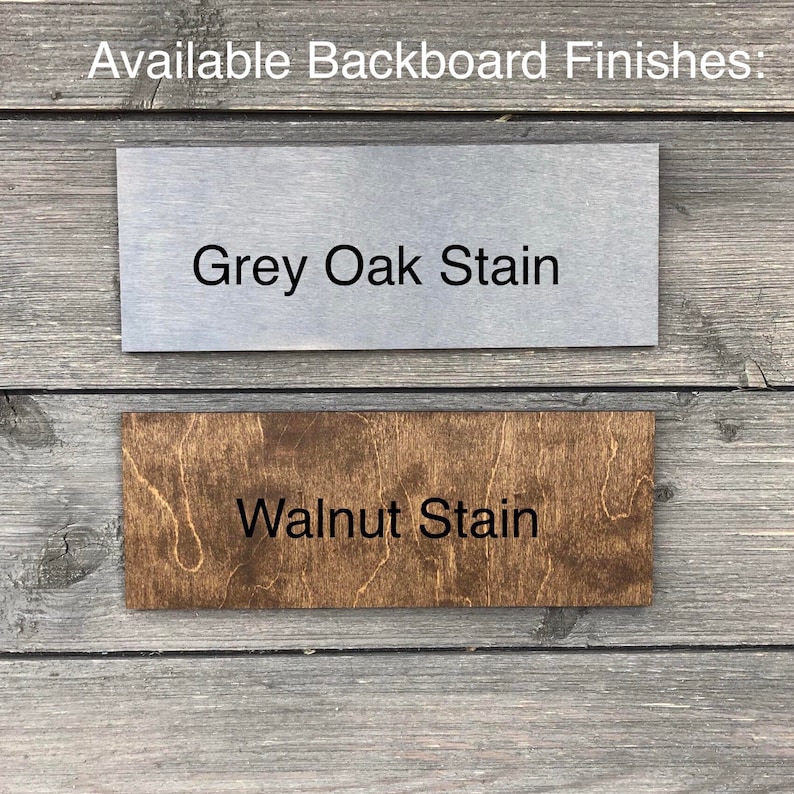 May include: Two wood samples showing different stain colors. The top sample is a light gray color with the text "Grey Oak Stain". The bottom sample is a dark brown color with the text "Walnut Stain".