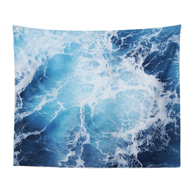 May include: A blue and white tapestry featuring a close-up of ocean waves with white foam.