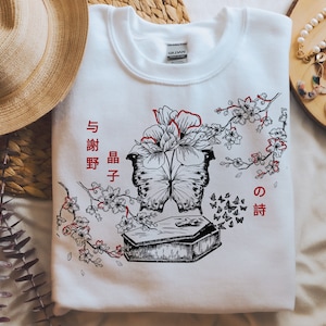 Japanese Author Inspired Floral Transformative Butterfly Death Graphic Crew Neck Sweatshirt - White
