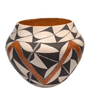 May include: A handcrafted ceramic pot with a wide, rounded body. The pot features a geometric design in black, white, and orange. The interior is a warm orange color, and the exterior has a matte finish.