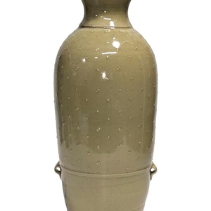 May include: A tall, olive-green ceramic vase with a bulbous body and a narrow neck. The vase has a textured surface with small, evenly spaced bumps. It features two small handles near the base and is suitable for home decor.