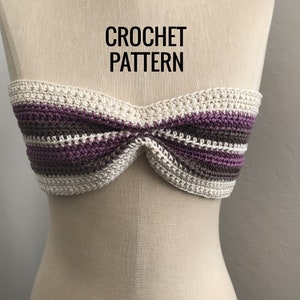 May include: A crocheted bandeau top with white and purple stripes. The top is on a white mannequin. The text "CROCHET PATTERN" is above the top.