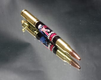 May include: A gold pen with a black and red design featuring an Uncle Sam illustration and the text "RUM HAM" and "IT'S EVERYWHERE".