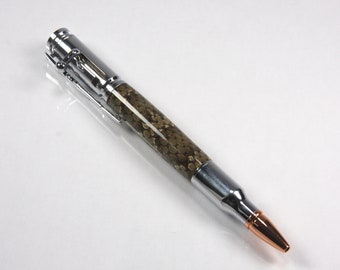 May include: A silver and copper bullet pen with a brown and gold patterned barrel.