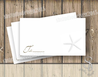 white and gold starfish wedding place card