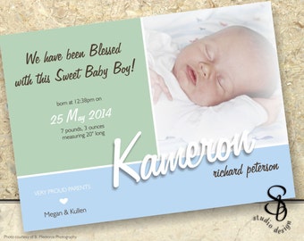 May include: A light blue and green baby announcement card with a photo of a sleeping baby. The card reads "We have been Blessed with this Sweet Baby Boy!" and includes the baby's name, birth date, weight, and length. The card also includes the parents' names and a heart.