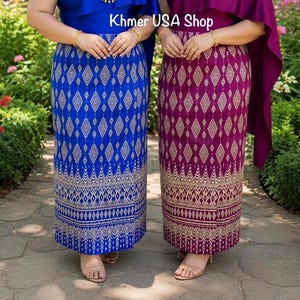 May include: Two long skirts, one in royal blue and one in deep magenta, both featuring a repeating gold diamond pattern and intricate lower border designs. The text Khmer USA Shop is visible at the top center of the image above the skirts.