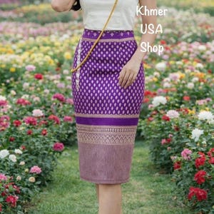 May include: A purple skirt with a diamond pattern and a decorative border. The skirt has a vertical striped pattern at the bottom. The text "Khmer USA Shop" is visible in the image.