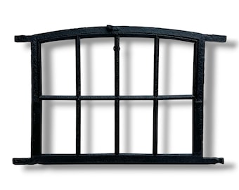 May include: Black metal window frame with a curved top and rectangular panes. The frame has a textured surface and is designed with horizontal and vertical bars, creating a grid pattern. The window frame is a decorative element.