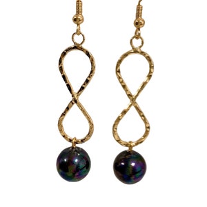 May include: Gold infinity earrings with iridescent black pearl drops.