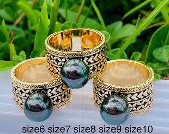 May include: Three gold rings with black pearl accents. The rings are engraved with a geometric pattern. The rings are labeled with sizes 6, 7, 8, 9, 10, 11, 12, 13, and 14.