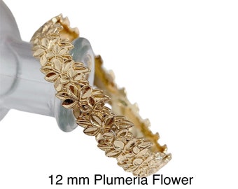 May include: Gold-tone ring featuring a 12 mm plumeria flower design. The ring is available in sizes 7.5, 8, and 10.