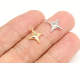 May include: Two metal star-shaped charms, one gold and one silver, with a loop at the top for attaching to jewellery or other crafts.