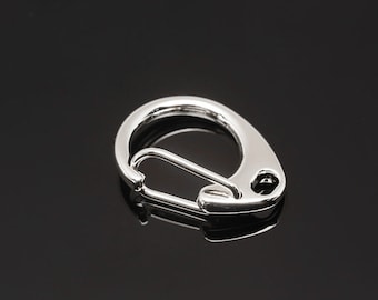 May include: A silver metal key chain hook with a spring-loaded clasp.