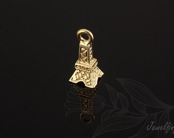 May include: Gold-coloured Eiffel Tower charm with a detailed design. The charm has a loop at the top for attaching to a necklace or bracelet.
