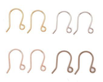 May include: A selection of earring hooks in gold, silver, rose gold, and bronze finishes. The hooks are presented on a white backdrop, highlighting their curved shape and looped ends. These are suitable for crafting jewellery.