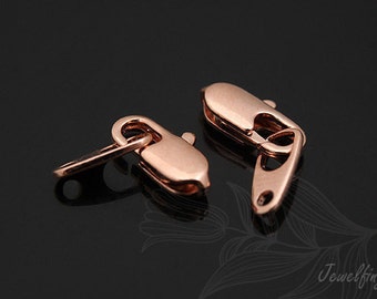 May include: Two rose gold lobster clasps for jewelry making. The clasps are made of metal and have a shiny finish.