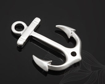 May include: A silver anchor charm with a smooth, polished finish. The anchor has a loop at the top for attaching to a necklace or bracelet.
