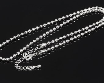 May include: A silver ball chain necklace with a lobster clasp closure.