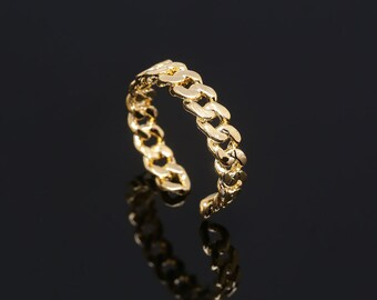 May include: A gold-toned ring with a thick, chunky chain design.