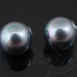 May include: Two iridescent black round beads with a slight green and purple sheen.