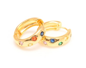 May include: A pair of gold hoop earrings with colorful gemstones. The earrings are made of gold metal and have a smooth finish. The gemstones are set in a circular pattern around the hoop.