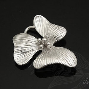 May include: Silver flower charm with a textured surface and a detailed centre. The charm is shaped like a four-leaf clover.