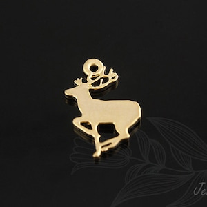 May include: Gold-coloured metal charm shaped like a deer with antlers. The charm is a cutout design, meaning the metal is hollow.