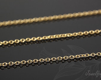 May include: A close-up of a gold chain necklace. The chain is made of small, round links.