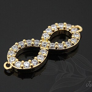 May include: Gold infinity charm with clear cubic zirconia stones.