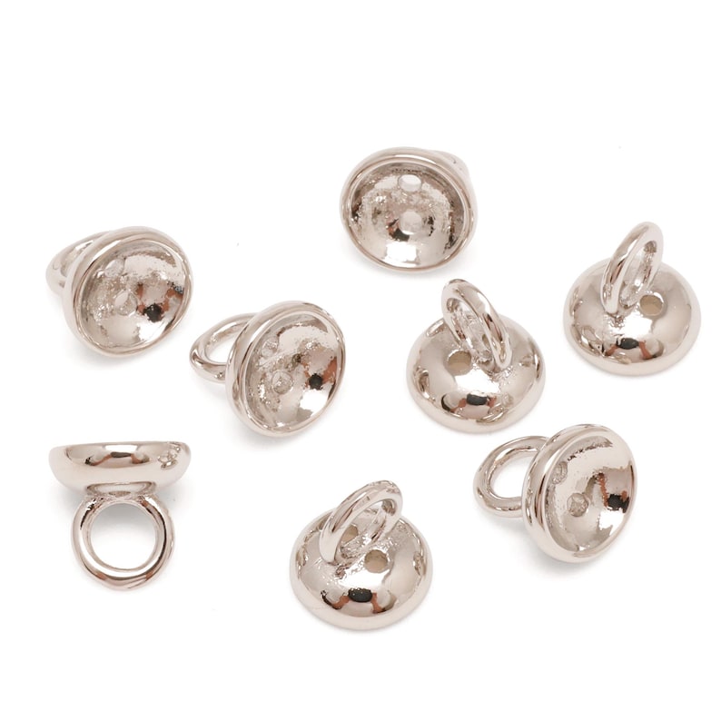 May include: A selection of silver-coloured metal jewellery findings, including ring bails and button-shaped components. The ring bails have a loop for attaching. The button-shaped pieces have a loop or hole for attaching.