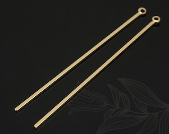 May include: Two gold-coloured metal earring posts with a loop at the top. The posts are straight and about 5 cm long.