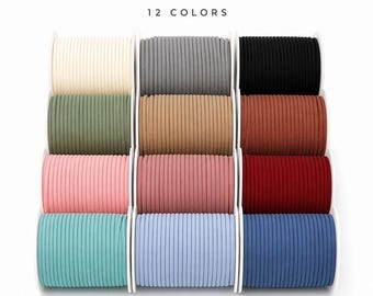 May include: Twelve spools of braided polyester cord arranged in a grid. The text BRAIDED POLYESTER CORD and 12 COLORS appears at the top. The colors include cream, gray, black, olive green, tan, rust, light pink, mauve, red, teal, light blue, and navy.