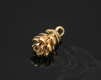 May include: A gold-colored metal pine cone charm with a loop for attaching to a necklace or bracelet.