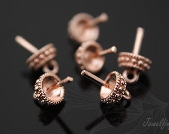 May include: Five rose gold bead caps with a textured design. The bead caps have a small loop on one end and a pin on the other end.