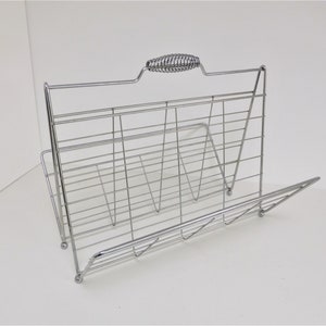 RESERVED----Newspaper or magazine rack, chrome.