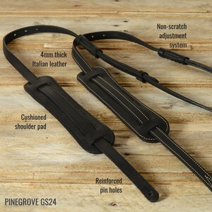 May include: Black leather guitar strap with a cushioned shoulder pad, reinforced pin holes, and a non-scratch adjustment system. The strap is 4mm thick and made of Italian leather. PINEGROVE GS24.