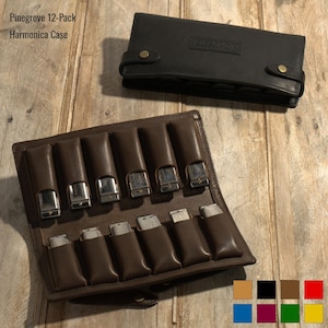 May include: A brown leather harmonica case with 12 slots for harmonicas. The case is open and the slots are empty. The case is made of high-quality leather and has a durable zipper closure. Pinegrove 12-Pack Harmonica Case.