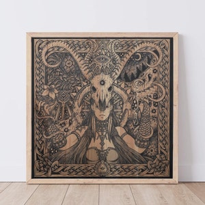 May include: A black and white illustration of a woman with a skull mask and horns. The woman is surrounded by intricate Celtic knotwork and other symbols. The artwork is framed in a light wood frame.